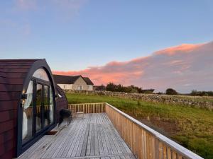 a deck of a small building with a bench on it at Bromach Lodge & NEW HOT TUB in Latheron +38 photos