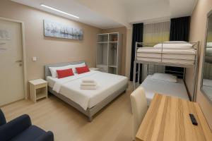 a small bedroom with a bunk bed and a table at Arkadia Hotelli in Helsinki