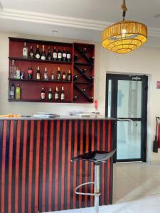 a bar with a black and red striped wall at Hotel Njenka in Yaoundé