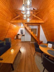 a living room with a wooden ceiling and a table at Art A Cabin in Teşila +31 photos