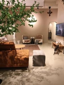 a living room with couches and a table at Senju Georgetown Heritage PrewarHouse 4BR 5-15 pax in George Town