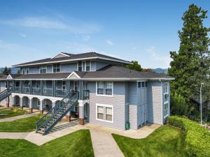 a large house with a staircase in front of it at 28 Lodge in Hood River
