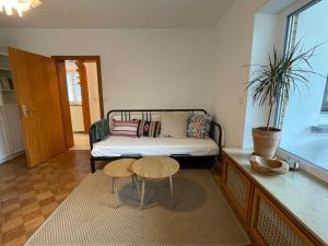 a bedroom with a bed and two chairs and a table at Das Grüne Nest in Neckarsteinach
