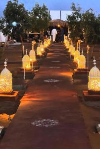 a row of lights lined up on a road at Comfort Luxury Camp in Merzouga