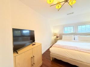 a bedroom with a large bed and a flat screen tv at Norwalk Retreat in Norwalk +19 photos