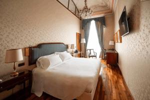 Ένα ή περισσότερα κρεβάτια σε δωμάτιο στο Phi Hotel Principe +58 φωτογραφίες