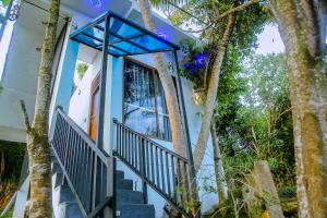 a house with stairs and a window and trees at Cozy 1BR Villa in Weligama Panoramic Sea View in Weligama