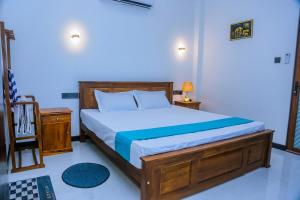 a bedroom with a large bed with a wooden frame at Cozy 1BR Villa in Weligama Panoramic Sea View in Weligama