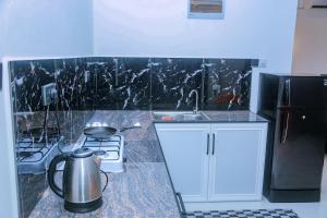 a kitchen with a sink and a stove and a refrigerator at Cozy 1BR Villa in Weligama Panoramic Sea View in Weligama