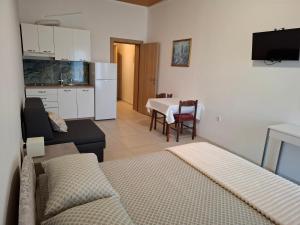 a living room with a couch and a table and a kitchen at Apartments Kod Cara in Lokva Rogoznica