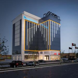 a large building with cars parked in front of it at Saray Deluxe Hotel Apartments in Abu Dhabi