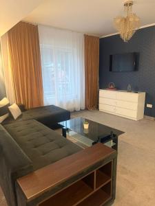 a living room with a couch and a coffee table at Blue Hotel Boutique & Spa in Buşteni