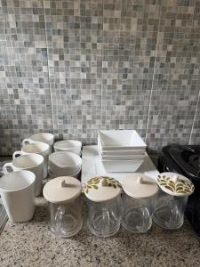 a counter with glass bowls and plates on it at Pandan de Bali in Ungasan