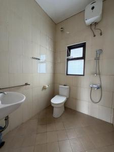 a bathroom with a toilet and a sink and a window at Pandan de Bali in Ungasan +15 photos