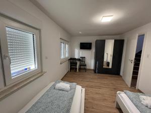 a bedroom with two beds and a large window at 92 City Rooms in Koblenz