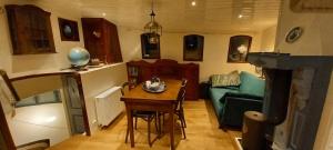 a living room with a table and a green couch at Klipper Engelburg in Zwolle +30 photos