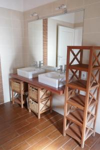 a bathroom with two sinks and a large mirror at Gîte les charrières in Pouzauges
