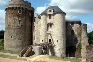 a large castle with a staircase in front of it at Gîte les charrières in Pouzauges