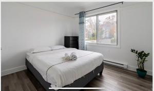 een slaapkamer met een bed met twee witte schoenen erop bij Comfortable 4B Unit-Close to City Attractions in Montreal