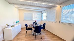 a dining room with a table and chairs at Bon Bon Suite by Ca-sa Check in Sottomarina