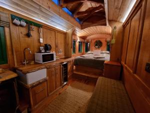 a kitchen with a bed and a sink in a room at The Loft Glamping & Camping in Kinloss