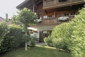 a house with a balcony on top of a yard at Alpenchalet Reit im Winkl in Reit im Winkl