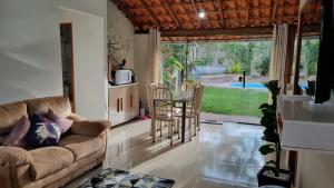 un soggiorno con un divano, un tavolo e delle sedie di Casa próxima a Cachoeira Grande a Santana do Riacho