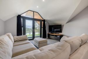 een woonkamer met een witte bank en een groot raam bij 5 Bed in Pancrasweek oc-l30443 in Pancrasweek