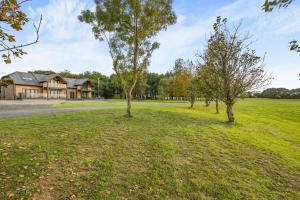 een open veld met bomen voor een huis bij 5 Bed in Pancrasweek oc-l30443 in Pancrasweek