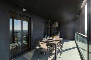 a dining room with a table and chairs on a balcony at Settimo Cielo - San Cristoforo in Milan