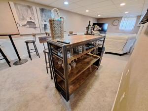 a room with a counter with a table with bottles at Location! Large Home, Country Views, Entertainment in Dubuque