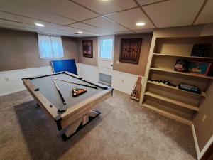 a game room with a pool table and shelves at Location! Large Home, Country Views, Entertainment in Dubuque