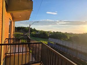 a balcony with a view of the countryside at Complejo Cambyreta Alojamiento temporario para 7 personas Encarnación Cerca de Playa San Jose in Cambyretá