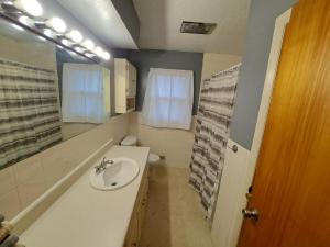a bathroom with a sink and a toilet and a mirror at Location! Large Home, Country Views, Entertainment in Dubuque +16 photos