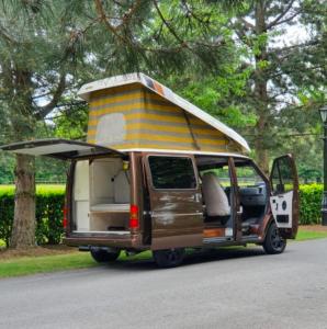 a small van with a camper on the side of the road at Retro Camper Hire in Dublin