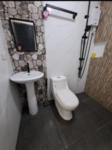 a bathroom with a toilet and a sink at Janice Place 2 in Marilao