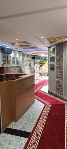 a lobby with a reception desk and a red carpet at APPART-HOTEL La MAISON ATTAWBA TERRASSE in Beni Mellal