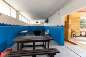 a room with a picnic table and a blue wall at Beach Retreat in Amanzimtoti