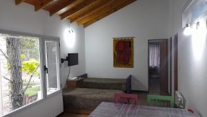 a living room with a table and chairs and a window at La casa de los Abuelos in Costa del Este
