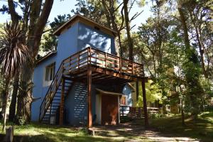 a tree house with a staircase leading up to it at La casa de los Abuelos in Costa del Este