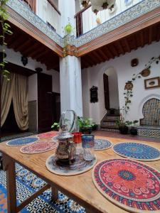 a table with plates and glasses on top of a room at hostel four seasons in Tétouan