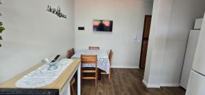 a small room with a table and a table and chairs at Apartamento Barra Vento 2 in Guriri +17 photos
