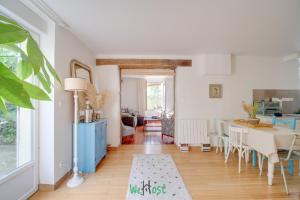a kitchen and dining room with a table and chairs at Orves - Seine-Saint-Denis - CI - Elegance and comfort with garden for 2 people in Le Pré-Saint-Gervais