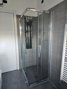 a shower with a glass door in a bathroom at Luca Apartment Rho in Rho