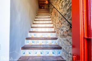 a set of stairs with blue and white tiles at Casa Jordi - Piedra y bóveda en el corazón de Cadaqués I 3 suites I 2 parkings I patio con bbq in Cadaqués