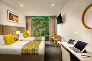 a hotel room with a bed and a desk at Quest Mounts Bay Road in Perth