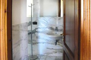 a bathroom with a sink and a mirror at Residence La Chiusa di Rio, Rio nell'Elba in Rio nellʼElba