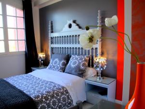 a bedroom with a bed and two tables with lamps at Le Mas de la Verrerie in Les Adrets de l'Esterel