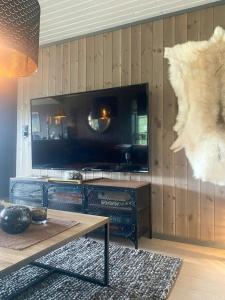a living room with a stove and a table at Renovated Cabin With Views In Trysil in Ljørdal