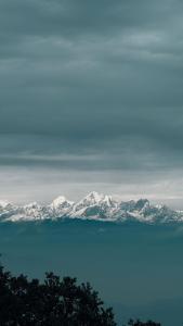 a view of the snow covered mountains across the water at Saura Point Homestay in Nagarkot